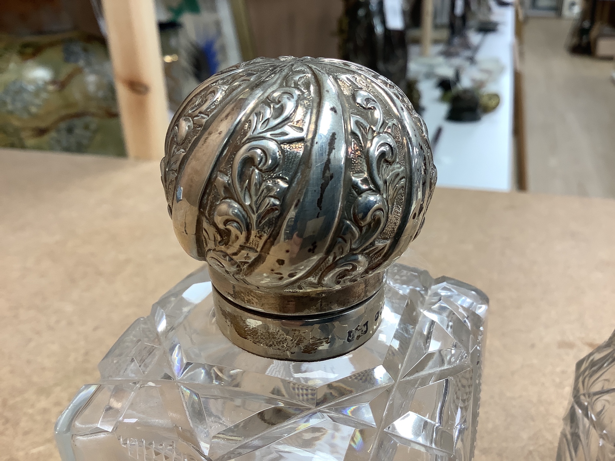 A late Victorian silver topped cut glass scent bottle, London, 1890, 15cm, a later silver mounted glass condiment ewer and silver mounted glass caster.